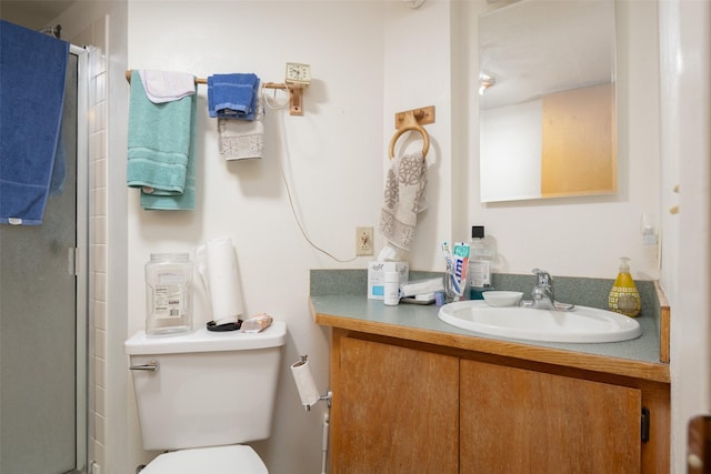 bathroom with vanity, an enclosed shower, and toilet