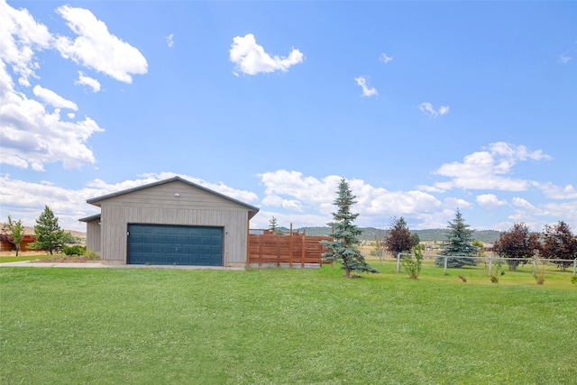 view of yard with a garage and an outdoor structure