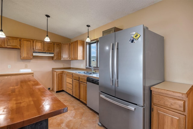 kitchen featuring lofted ceiling, sink, hanging light fixtures, light tile patterned floors, and stainless steel appliances