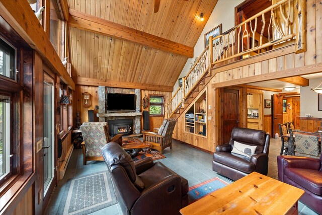 living room with wood walls, a fireplace, and tile patterned flooring