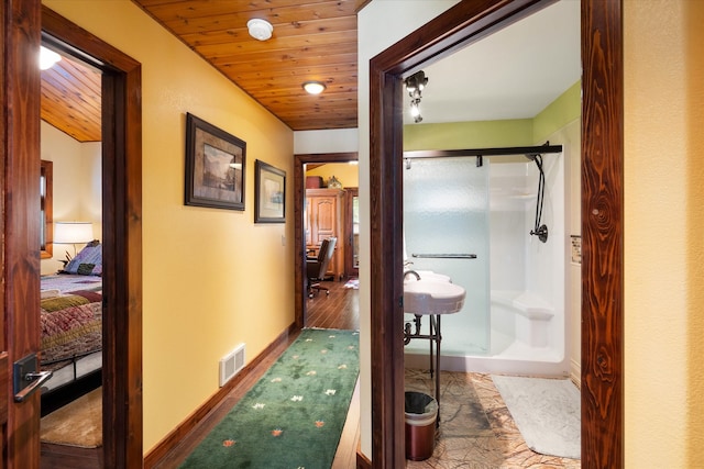 corridor with hardwood / wood-style floors and wood ceiling