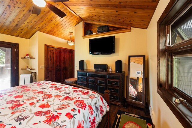 bedroom featuring a closet, ceiling fan, dark hardwood / wood-style flooring, lofted ceiling, and wood ceiling