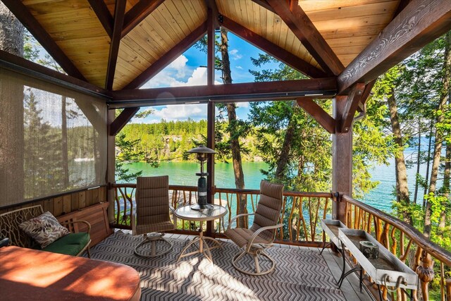 wooden terrace featuring a water view