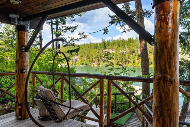 wooden deck featuring a water view