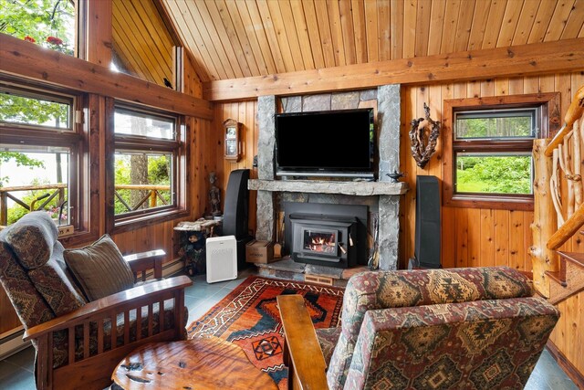 tiled living room with a wood stove, wooden walls, vaulted ceiling, a stone fireplace, and wood ceiling