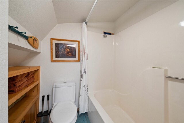 bathroom featuring shower / tub combo with curtain and toilet