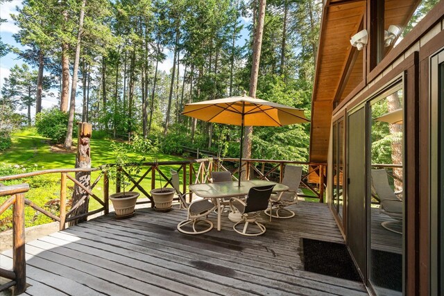 wooden deck featuring a lawn