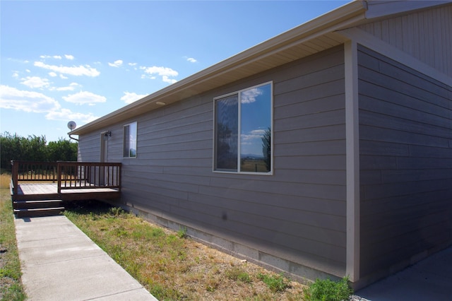 view of side of property with a wooden deck