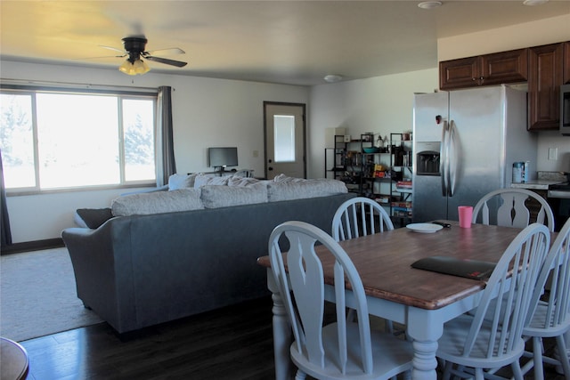 dining space with ceiling fan and dark wood-type flooring