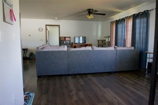 living room featuring dark hardwood / wood-style flooring and ceiling fan