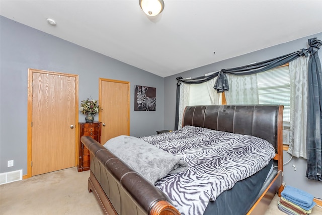 carpeted bedroom featuring lofted ceiling