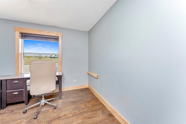 office space featuring lofted ceiling and light hardwood / wood-style floors