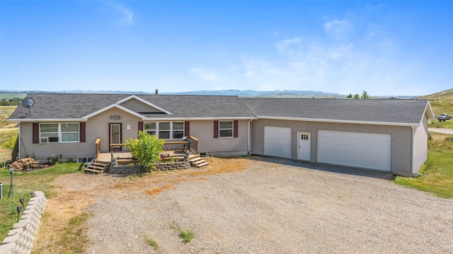 ranch-style home with a garage and a mountain view