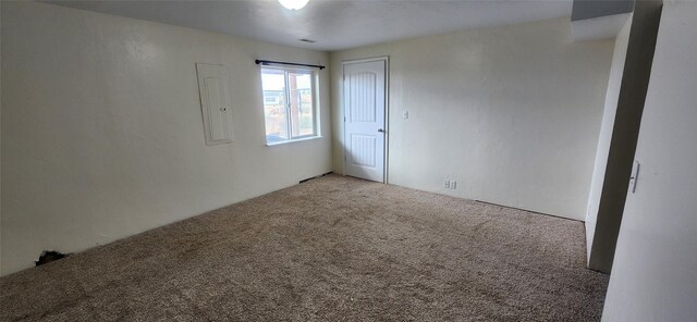 spare room featuring carpet and electric panel