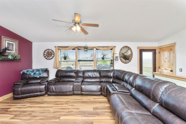 living room with ceiling fan, light wood-type flooring, and a wealth of natural light