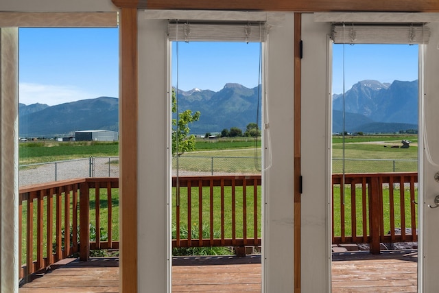 doorway to outside with a mountain view, a rural view, and light hardwood / wood-style flooring