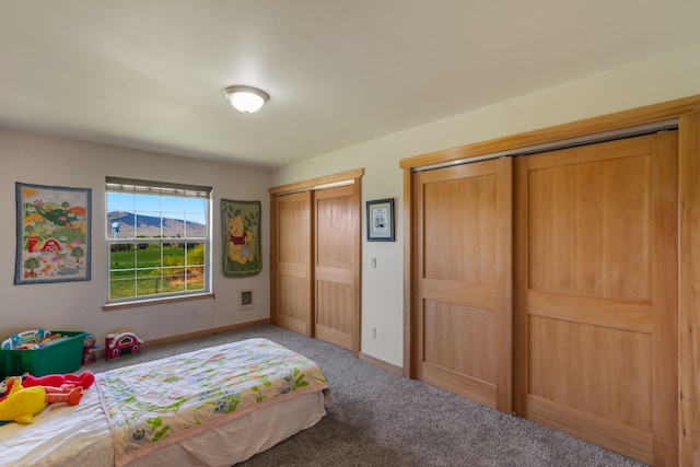 carpeted bedroom featuring two closets