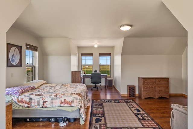 bedroom featuring lofted ceiling and dark wood-type flooring