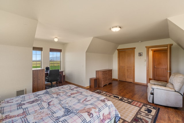 bedroom with dark hardwood / wood-style floors and vaulted ceiling