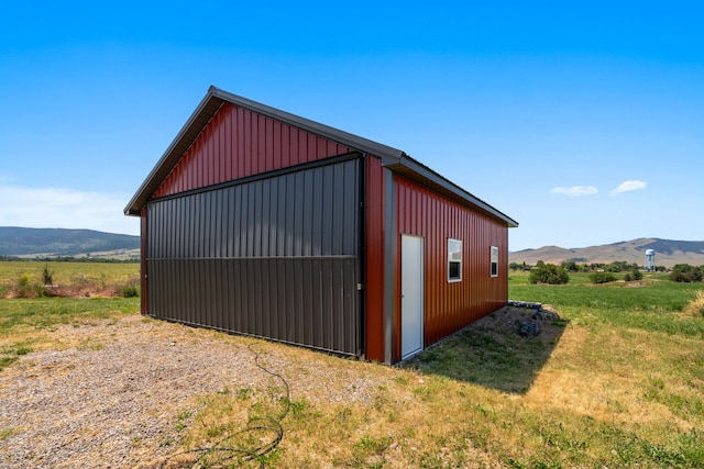 view of outbuilding with a mountain view and a rural view