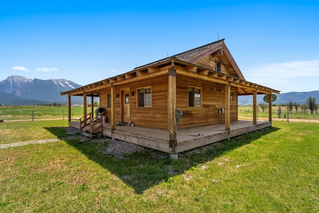 exterior space featuring a mountain view, a yard, and a rural view