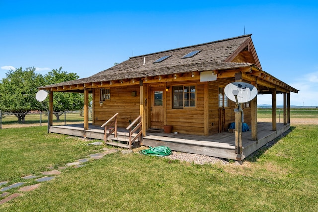 back of house featuring a yard