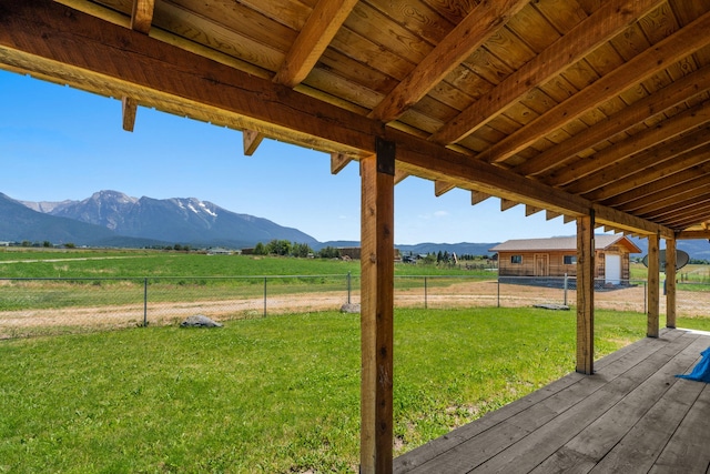 exterior space featuring a lawn, a mountain view, and a rural view