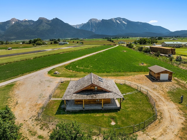 view of property's community with a mountain view, an outbuilding, and a rural view