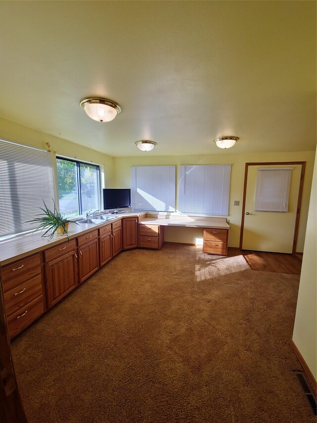 512 S Oak St, Townsend, MT 59644 - kitchen featuring brown cabinets, carpet, light countertops, visible vents, and a sink