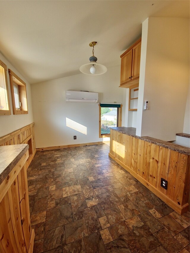 512 S Oak St, Townsend, MT 59644 - kitchen with baseboards, stone finish floor, a wall mounted AC, and hanging light fixtures