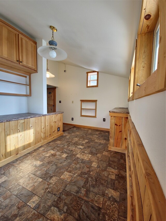 512 S Oak St, Townsend, MT 59644 - kitchen with lofted ceiling, baseboards, and stone finish flooring