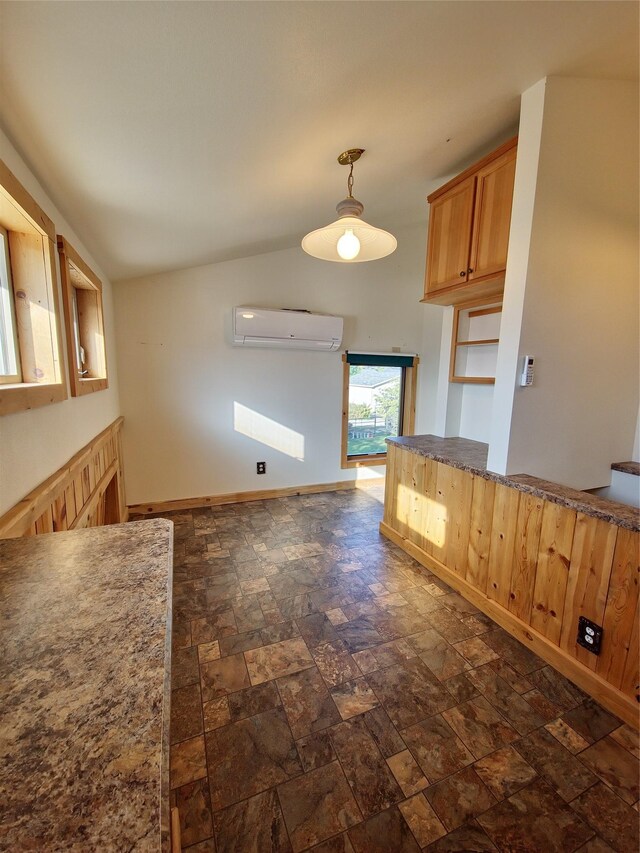 512 S Oak St, Townsend, MT 59644 - kitchen featuring lofted ceiling, stone finish floor, a wall unit AC, and hanging light fixtures
