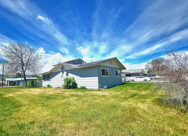 view of side of home with a lawn