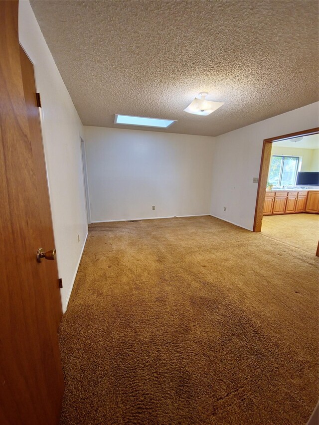512 S Oak St, Townsend, MT 59644 - carpeted spare room featuring a textured ceiling