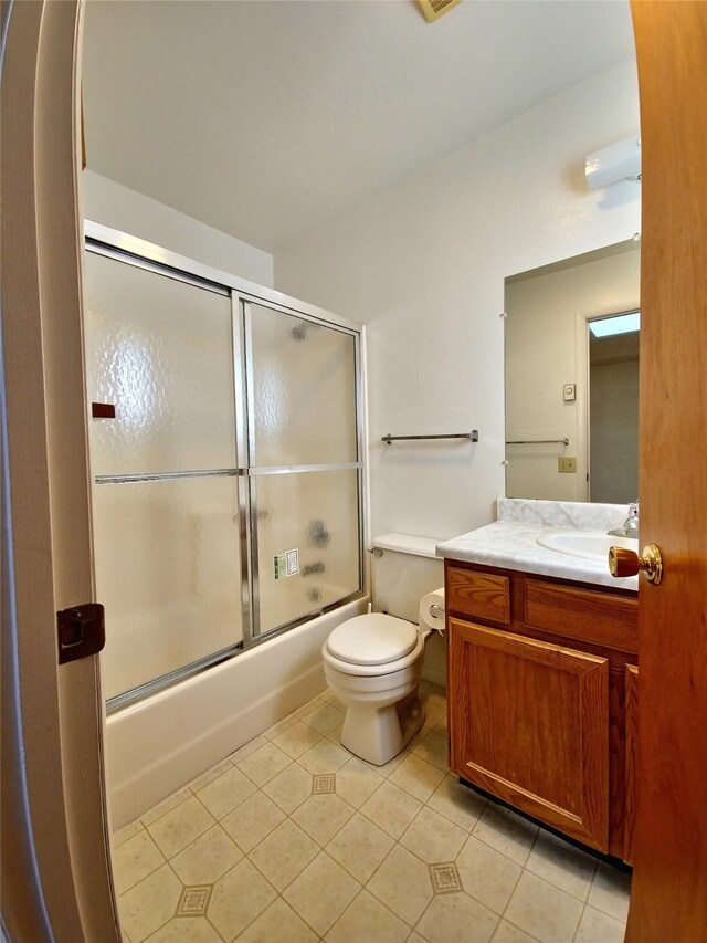 512 S Oak St, Townsend, MT 59644 - full bath with vanity, tile patterned floors, bath / shower combo with glass door, and toilet