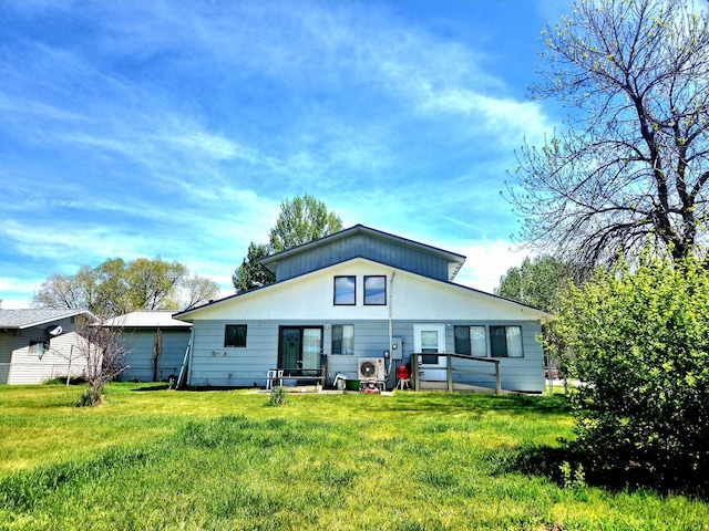 back of house with a lawn