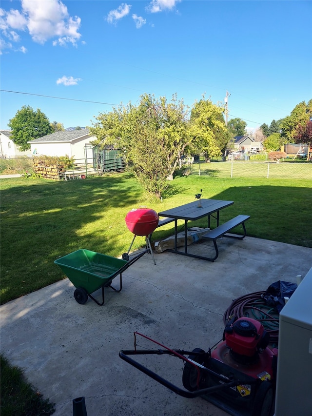 view of community with a lawn and a patio area