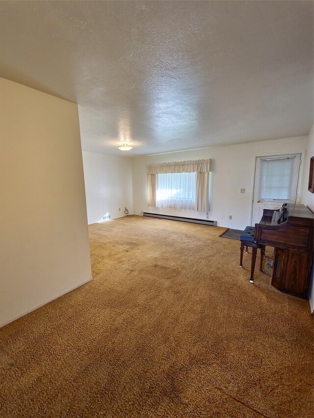 512 S Oak St, Townsend, MT 59644 - carpeted spare room with a baseboard heating unit