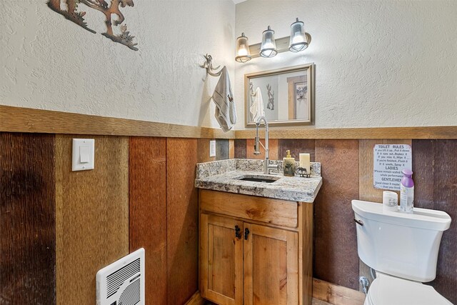 bathroom featuring toilet and vanity