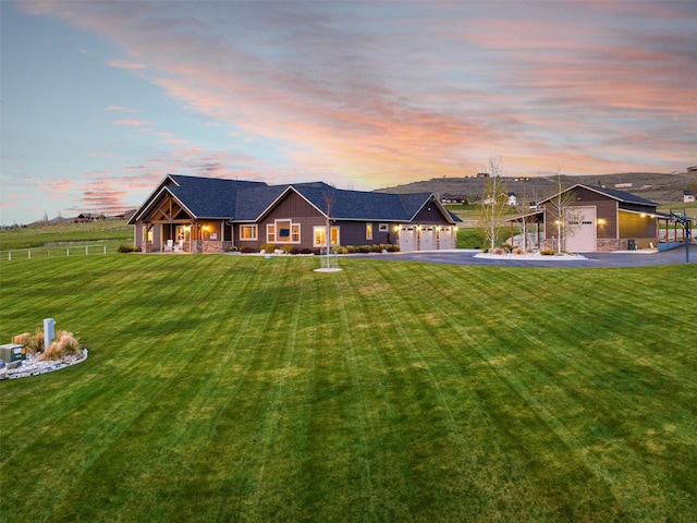 view of front of house with a yard and a garage