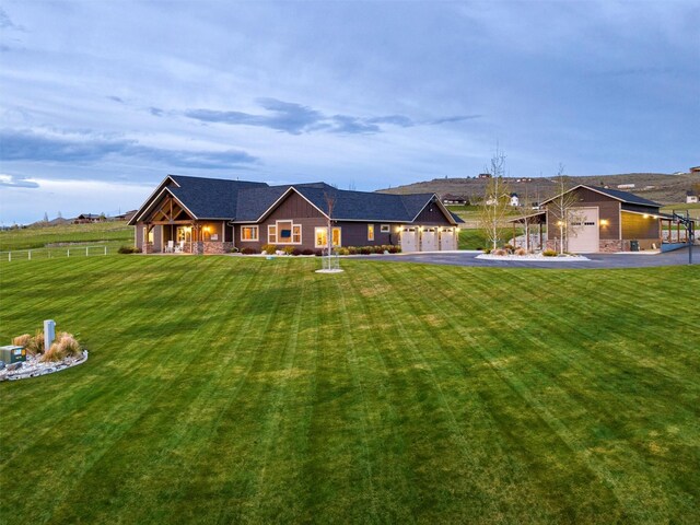 ranch-style house with a patio and a lawn