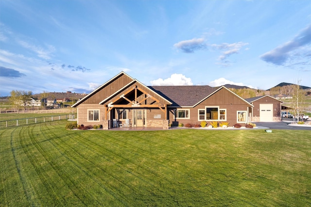 view of front facade with a garage, a mountain view, and a front yard