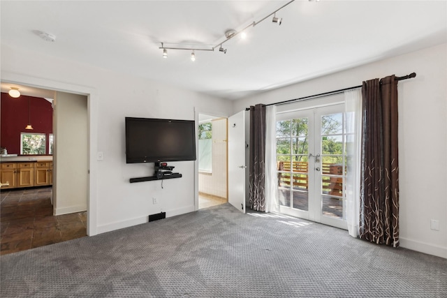 963 Colorado Ave, Whitefish, MT 59937 - unfurnished living room with dark colored carpet and french doors
