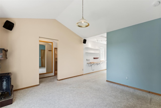963 Colorado Ave, Whitefish, MT 59937 - unfurnished living room featuring carpet, vaulted ceiling, and a wood stove