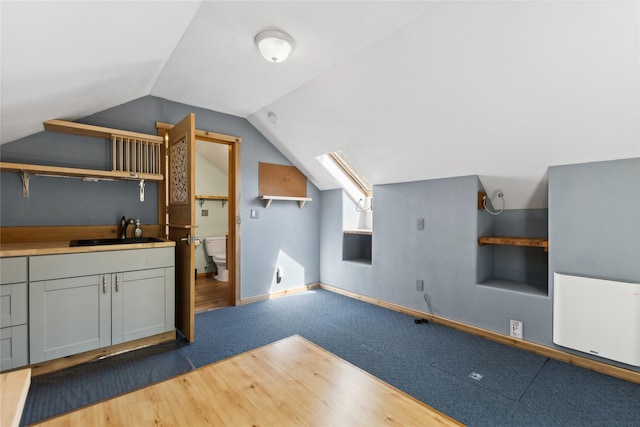 963 Colorado Ave, Whitefish, MT 59937 - additional living space with vaulted ceiling, carpet, and wood finished floors