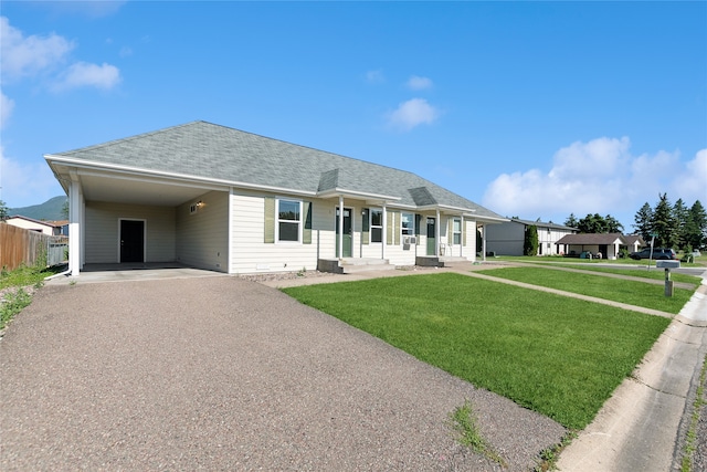 ranch-style home with a carport and a front lawn