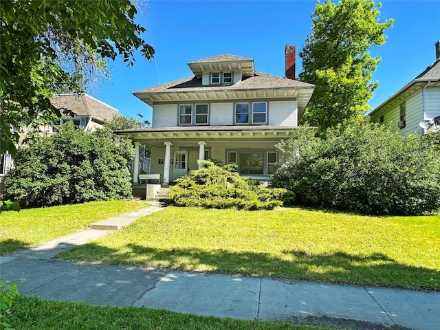 view of front of home featuring covered porch and a front yard