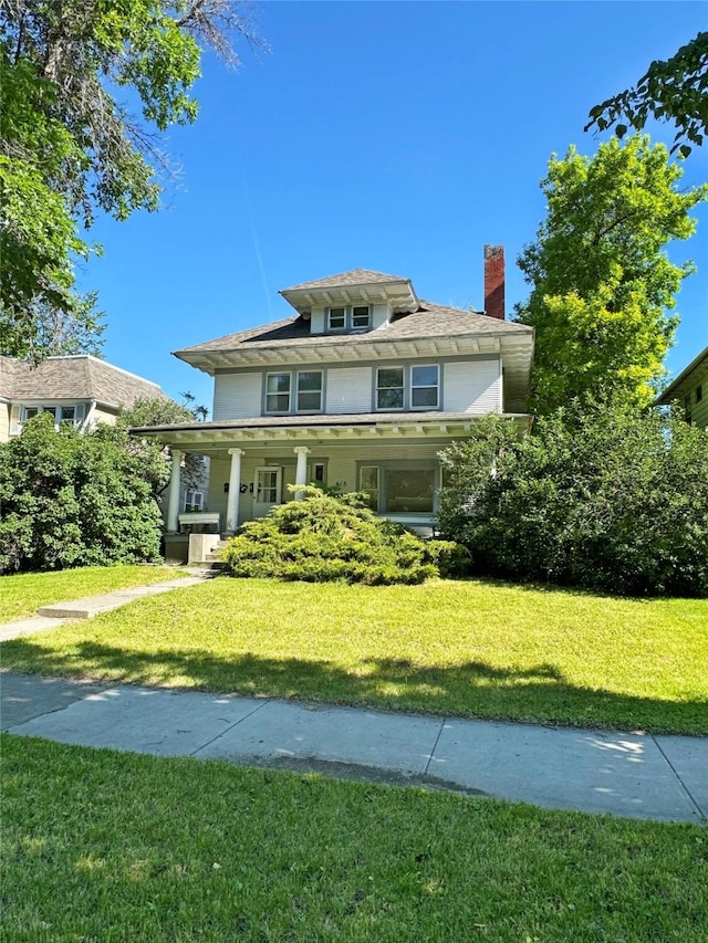 view of front of house with a porch and a front yard