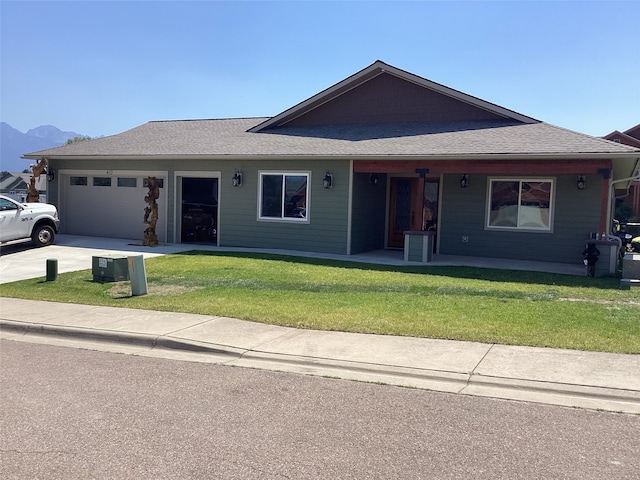 view of front of home featuring a garage and a front yard