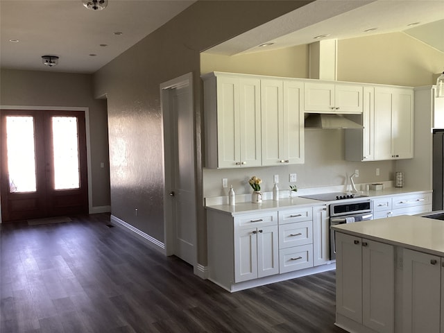 kitchen featuring dark hardwood / wood-style floors, white cabinetry, vaulted ceiling, and appliances with stainless steel finishes